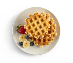 A plate with 2 waffles and fruit, prepared with Optavia Ascend Waffle and Pancake Mix.