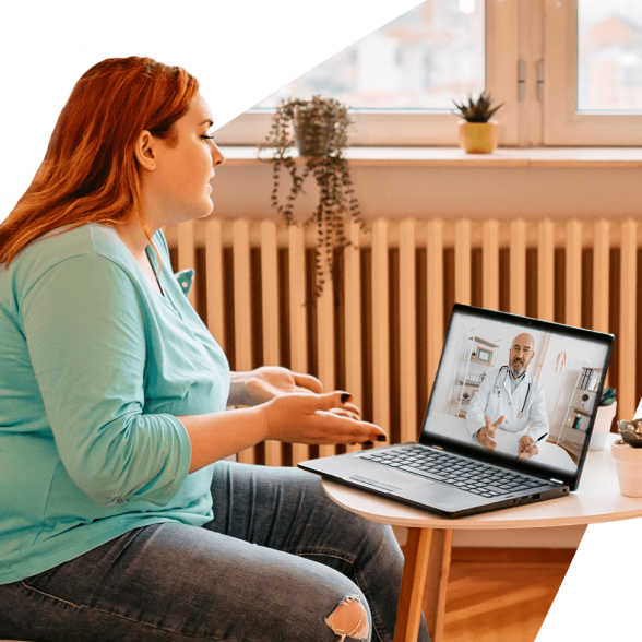 Woman using laptop for a teledoc call with a physician.